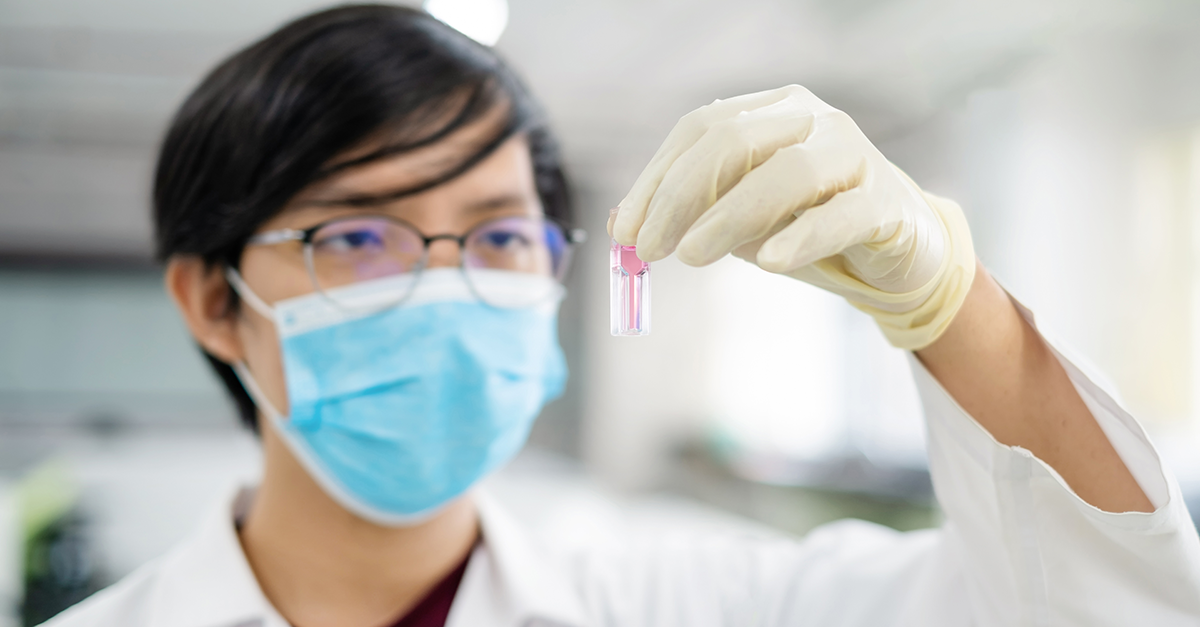 Scientist Holding Quartz Cuvette